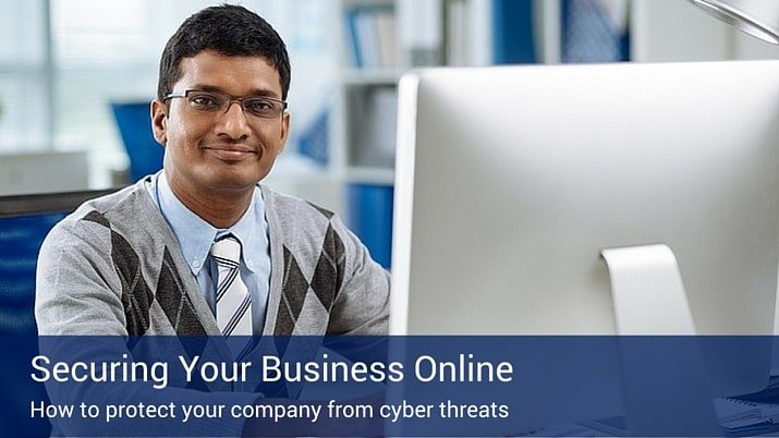 A man sitting at a computer with a blue sign on the bottom on the picture that says "Securing Your Business online".