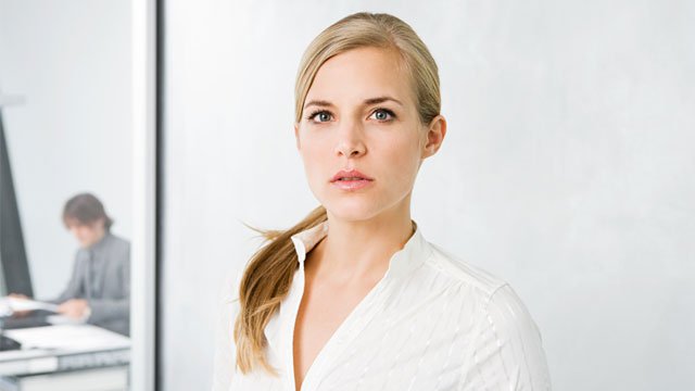 A headshot of a business woman working as a federal contract manager.