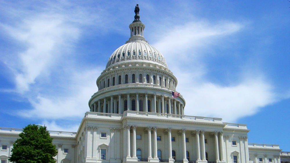 The State Capitol building against the backdrop of a clear, blue sky.