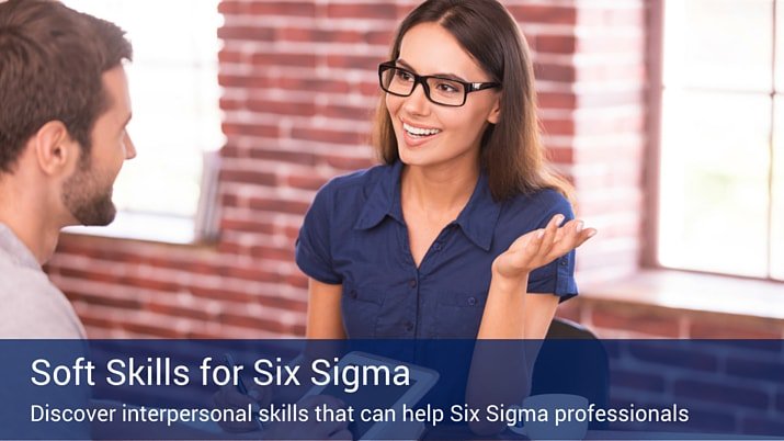 A businesswoman wearing glasses talking to a man about the soft skills that are important for six sigma professionals.